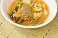 Boiled mixed vegetable topping fried fish and egg in Thai spicy soup on bowl Royalty Free Stock Photo