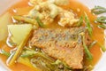 Boiled mixed vegetable topping fried fish and egg in Thai spicy soup on bowl Royalty Free Stock Photo