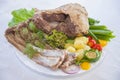 Boiled mutton laid out on a platter with vegetables.