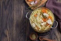 Boiled noodles with chicken in a saucepan with copy space