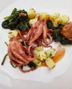 Boiled octopus with salad potatoes, spinach and creamy sauce