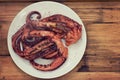 Boiled octopus on white plate Royalty Free Stock Photo