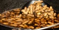 Boiled peanuts being scooped up with a strainer