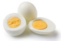 Boiled peeled eggs on a white background, one whole egg two eggs are cut in half, the yolk is visible Royalty Free Stock Photo