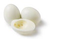Boiled peeled eggs on a white background, two whole eggs, one egg cut in half, half without yolk, concept Royalty Free Stock Photo
