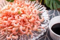 Boiled peeled shrimp with soy sauce on a plate. Royalty Free Stock Photo