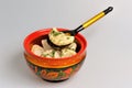 Boiled pelmeni in khokhloma painted russian wooden bowl with spoon