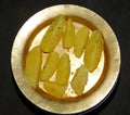 Boiled potato on golden dish, isolated with black background