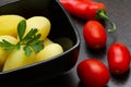 Boiled potatoes with chili peppers and tomatoes on a dark background Royalty Free Stock Photo