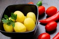 Boiled potatoes with chili peppers and tomatoes on a dark background Royalty Free Stock Photo