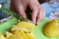 boiled potatoes are cut with a knife into cubes. food preparation Royalty Free Stock Photo