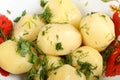 Boiled potatoes with oil and chopped dill leaves and parsley leaves in white porcelain plate Royalty Free Stock Photo