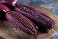 Boiled purple corn on wooden tray in rustic kitchen