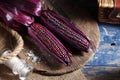 Boiled purple corn on wooden tray in rustic kitchen