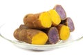 Boiled purple and yellow yams in plate on white background