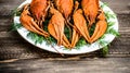 Boiled red crawfish on a white plate with green fennel on a wooden background.