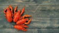 Boiled red crayfish on a wooden table surface, top view. Snack for beer Royalty Free Stock Photo