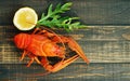 Boiled red crayfish on a wooden table surface, top view. Snack for beer