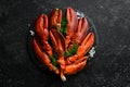 Boiled red lobster claws with spices and parsley on a black stone plate. On a black background. Rustic style. Royalty Free Stock Photo