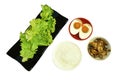 Boiled rice in bowl eat couple salty egg and crispy fried squid with lettuce on white background