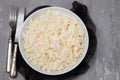 Boiled rice in a bowl on gray background. Royalty Free Stock Photo