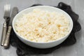 Boiled rice in a bowl on gray background. Royalty Free Stock Photo