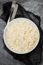 Boiled rice in a bowl on gray background. Royalty Free Stock Photo