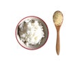 Boiled rice in bowl with raw jasmine rice in wooden spoon top view isolated on white background. Royalty Free Stock Photo