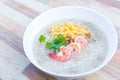 Boiled rice with pork was added on top with chopped omelet, boiled shrimp and coriander as a a breakfast meal in the morning in