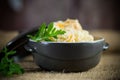 boiled rice with vegetables and meat in a ceramic bowl on a wooden table Royalty Free Stock Photo