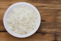 Boiled rice on white bowl on brown background Royalty Free Stock Photo