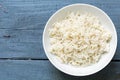Boiled rice in a white china bowl on rustic blue wood Royalty Free Stock Photo
