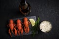 Boiled river crayfish with lemon and dill on slate and bottle with glass of foam beer. Royalty Free Stock Photo