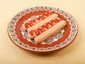 Boiled sausage with mustard on a plate Royalty Free Stock Photo