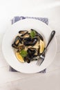 Boiled scottish mussels in a deep dish with parsley and lemon