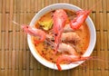 Boiled shrimp falling in Thai spicy soup or tom yum kung on bowl