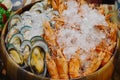 Boiled shrimp and mussel preserved with ice in wooden basin Royalty Free Stock Photo