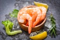 Boiled shrimps prawns on ice frozen at the seafood restaurant fresh shrimp on dark plate with lemon rosemary ingredients herb and Royalty Free Stock Photo