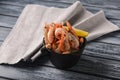 Boiled shrimps served with lemon in a small bowl over rustic wooden background with cloth Royalty Free Stock Photo