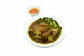 Boiled slice pork leg with pickled cabbage and Chinese kale in black herb soup on plate dipping spicy sauce Royalty Free Stock Photo