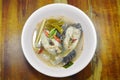 Boiled snake head fish in hot and spicy tom yum soup on bowl