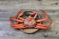 Boiled snow crab on a bamboo colander isolated on a wooden background