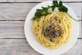 Boiled spaghetti and fried mushrooms on a white plate. Royalty Free Stock Photo