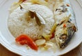 Boiled spicy mackerel with herb and rice on dish