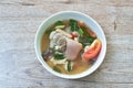 Boiled spicy pork leg in tom yum soup on bowl