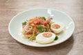 Boiled spicy salty egg half cut with dry shrimp and ginger salad on plate Royalty Free Stock Photo