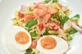 Boiled spicy salty egg half cut with dry shrimp and ginger salad on plate Royalty Free Stock Photo