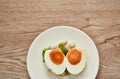 Boiled spicy salty egg half cut with slice shallot and chili salad on plate Royalty Free Stock Photo