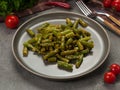 boiled string beans on a gray plate. vegetarian dish