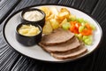 Boiled veal or Tafelspitz is the king of the beef dishes in Vienna close-up in a plate. horizontal